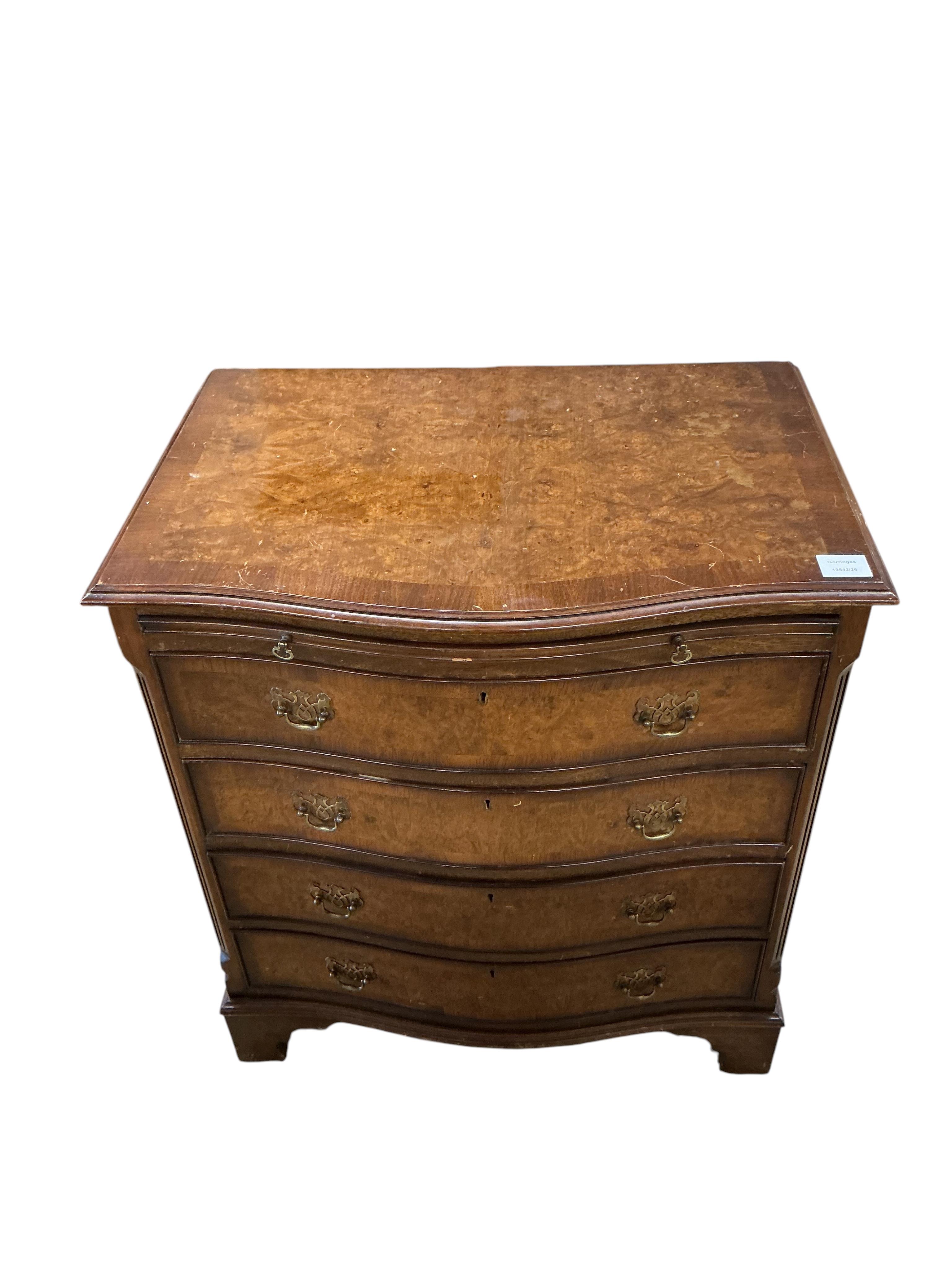 A reproduction George I style walnut serpentine four drawer chest, with brushing slide, width 70cm, depth 48cm, height 77cm